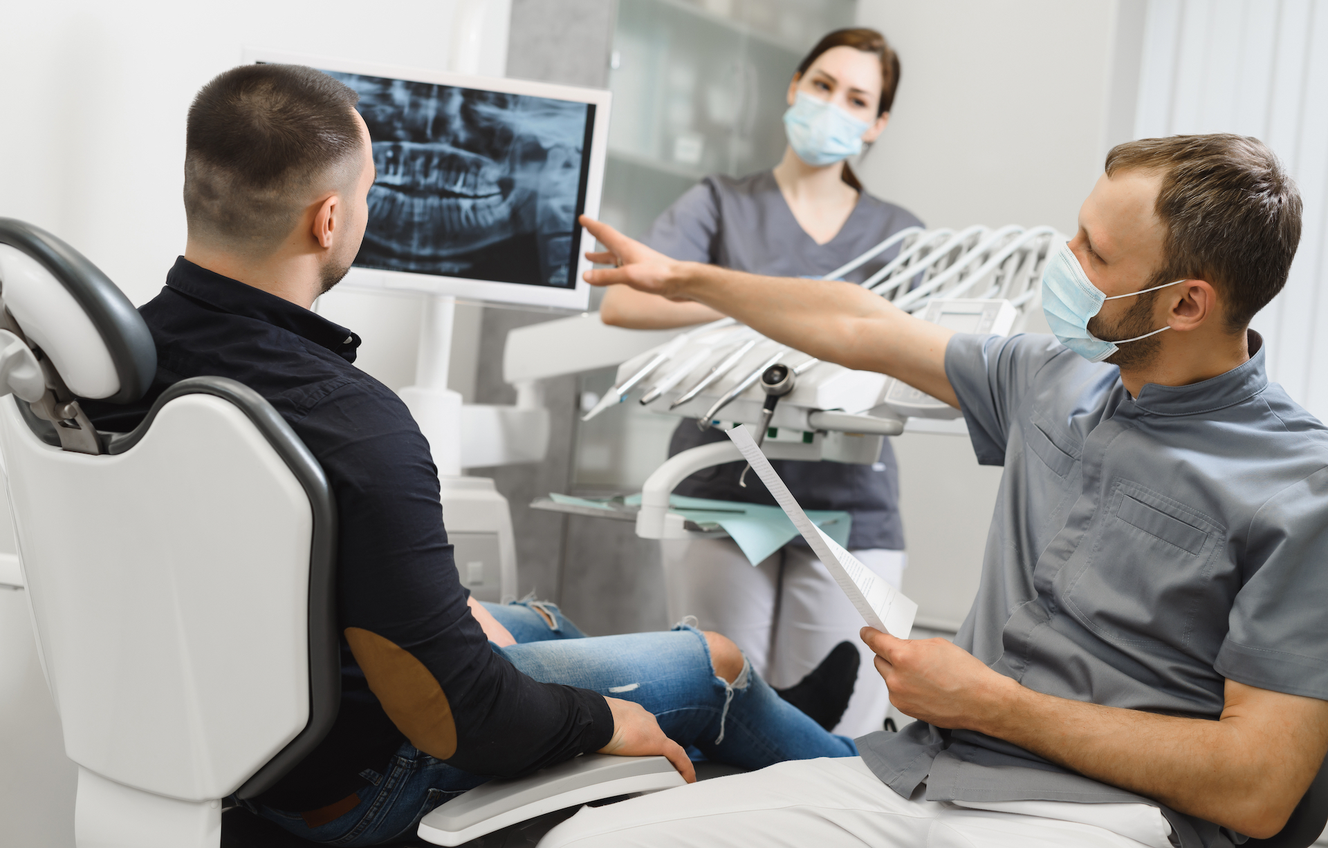 Dentists showing pointing at scans